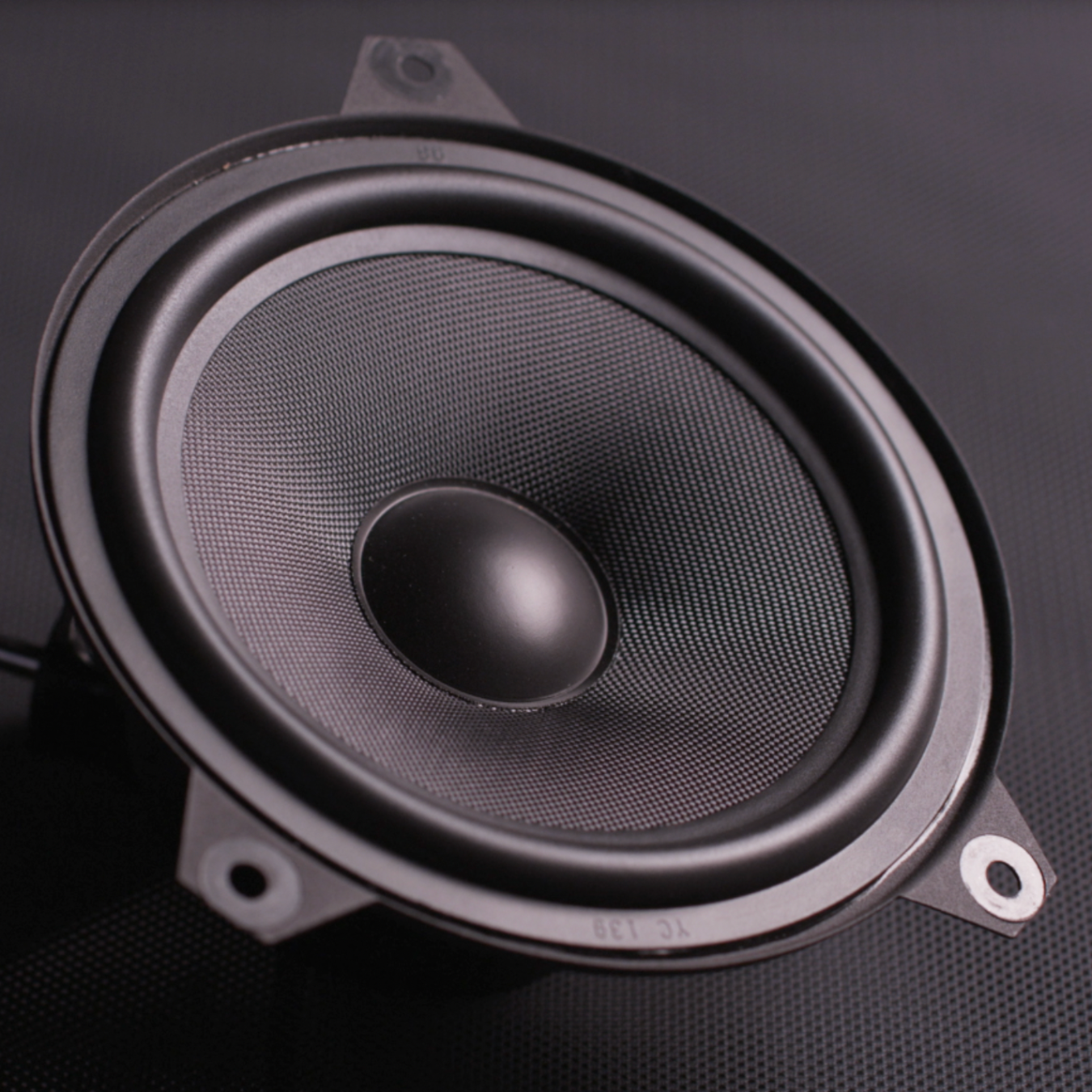 Close up image of a Bavsound speaker on a dark gray background. 